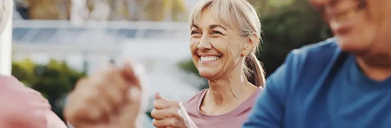 Smiling older woman in exercise clothing outdoors