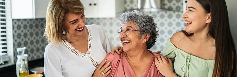 Three women in a home kitchen setting
